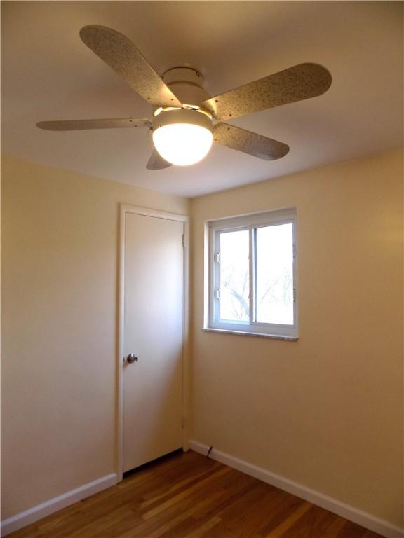 unfurnished room featuring ceiling fan and wood-type flooring