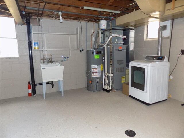 laundry room featuring washer / clothes dryer and water heater