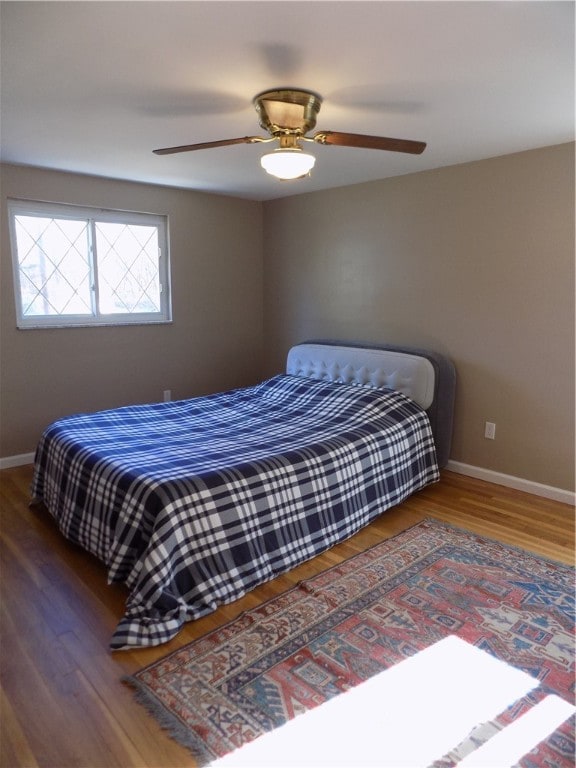 bedroom with ceiling fan and wood-type flooring