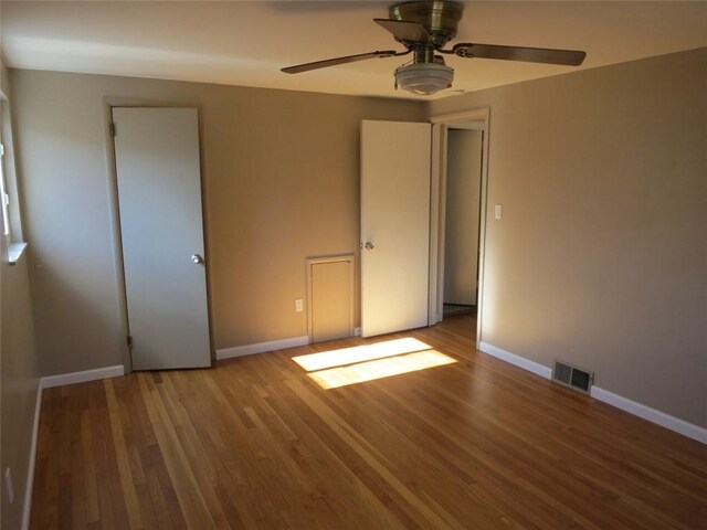 unfurnished bedroom featuring hardwood / wood-style flooring and ceiling fan