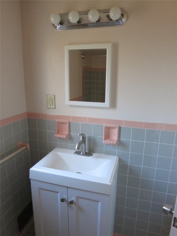 bathroom with vanity and tile walls