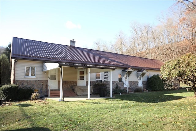 497 Pike Run Dr, W Pike Run Twp, PA 15427 - rear view of house with a chimney, stone siding, a yard, metal roof, and a patio area