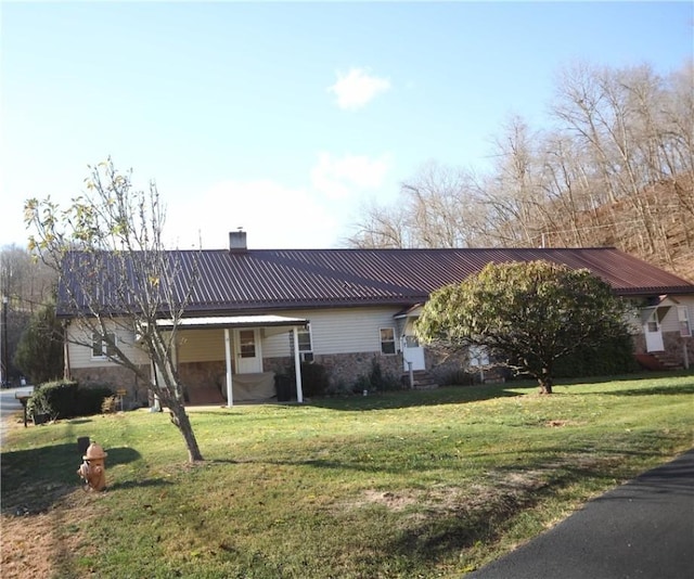 497 Pike Run Dr, W Pike Run Twp, PA 15427 - view of front facade featuring a chimney, a front yard, metal roof, and stone siding