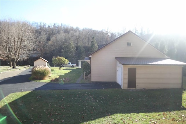 497 Pike Run Dr, W Pike Run Twp, PA 15427 - view of side of property with a garage, a lawn, and an outbuilding