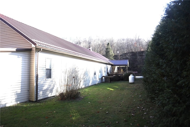 view of property exterior with a lawn