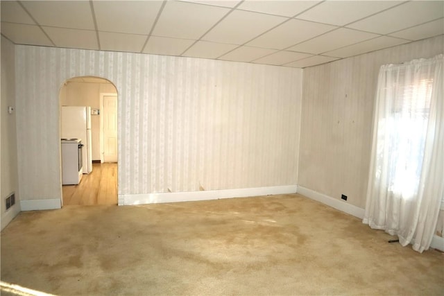 497 Pike Run Dr, W Pike Run Twp, PA 15427 - empty room featuring arched walkways, light carpet, a drop ceiling, and baseboards