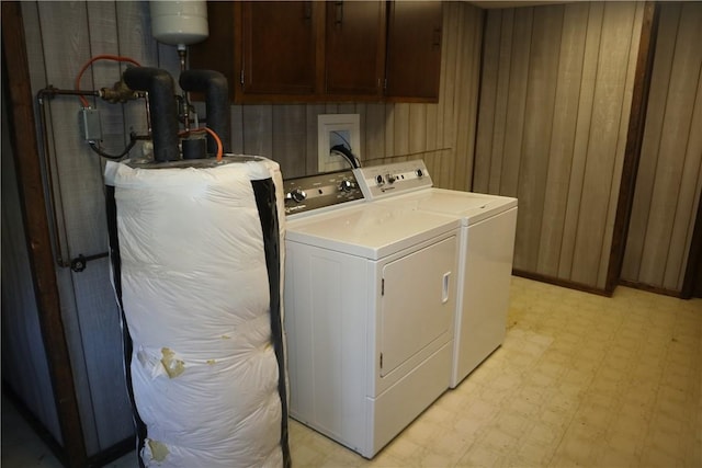 497 Pike Run Dr, W Pike Run Twp, PA 15427 - clothes washing area featuring washer and clothes dryer, light floors, cabinet space, and wood walls