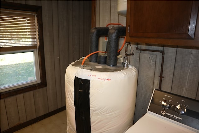 utility room featuring gas water heater and washer / dryer