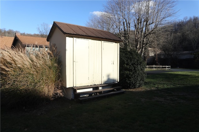 view of outbuilding with a lawn