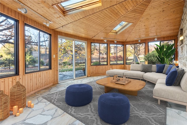 sunroom / solarium featuring vaulted ceiling with skylight, rail lighting, and wood ceiling