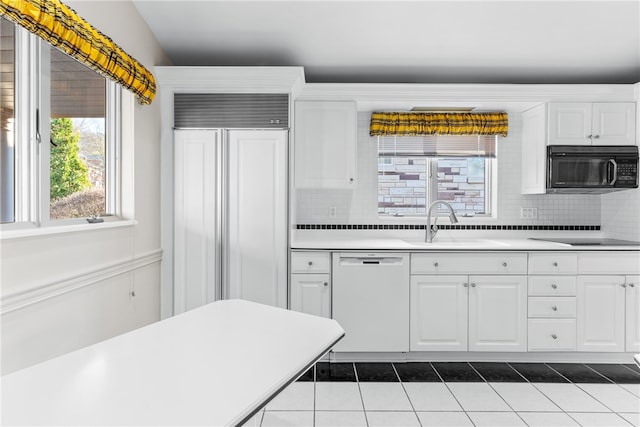 kitchen with white cabinets, sink, dishwasher, and paneled refrigerator