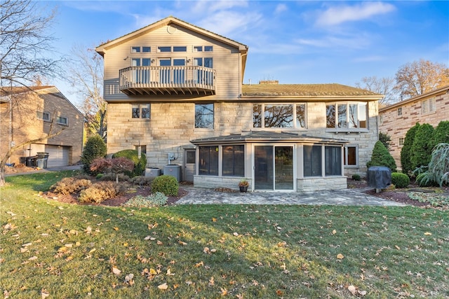 back of house featuring a patio, a balcony, cooling unit, and a yard