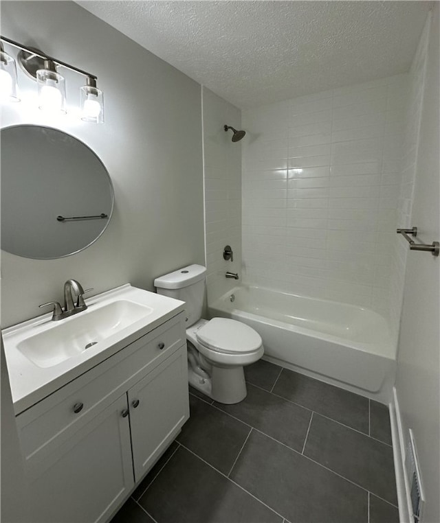 full bathroom featuring tile patterned floors, vanity, a textured ceiling, toilet, and tiled shower / bath