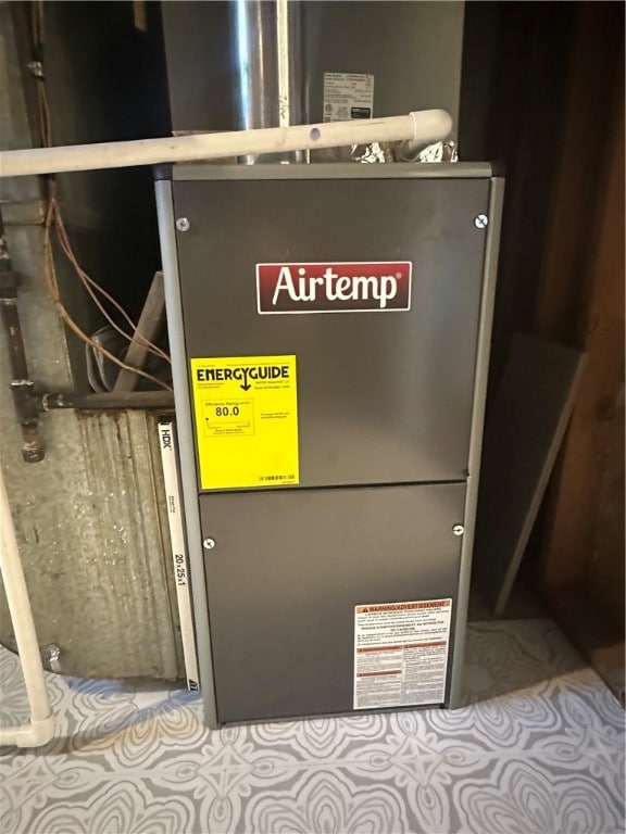 utility room featuring heating unit