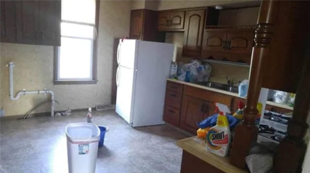 kitchen with sink and white refrigerator