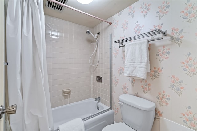 bathroom with toilet and shower / tub combo with curtain