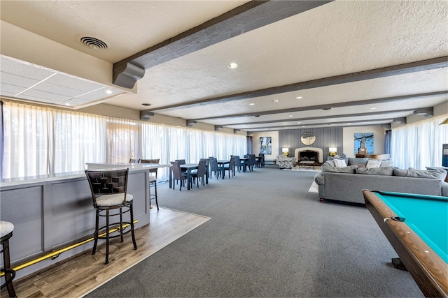 game room featuring hardwood / wood-style floors, beam ceiling, a textured ceiling, and billiards