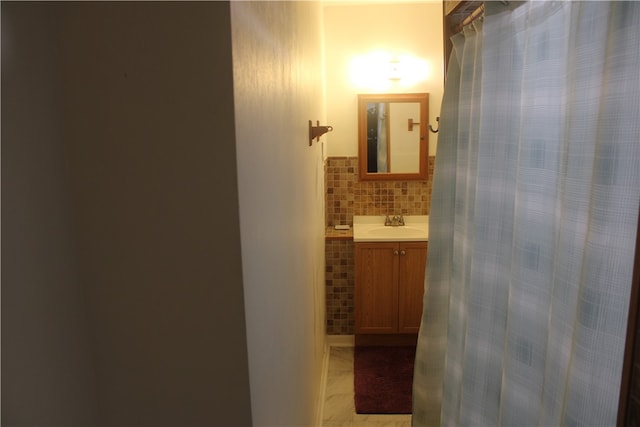 bathroom with tile patterned flooring, vanity, and tasteful backsplash