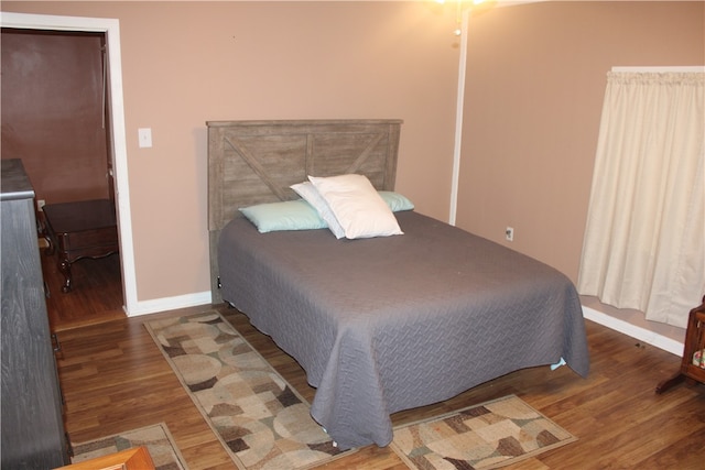 bedroom featuring dark wood-type flooring