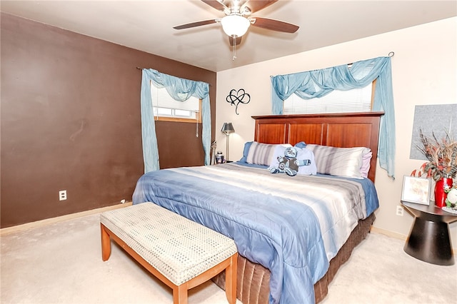 carpeted bedroom with multiple windows and ceiling fan