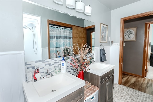 bathroom featuring vanity, decorative backsplash, hardwood / wood-style flooring, and curtained shower