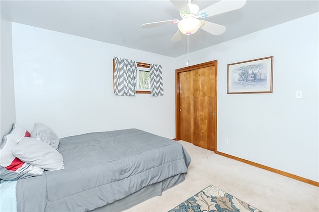 carpeted bedroom with a closet and ceiling fan