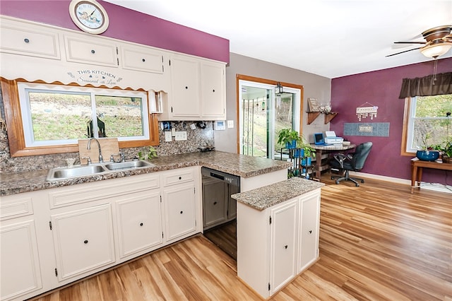 kitchen featuring sink, white cabinets, dishwasher, kitchen peninsula, and light hardwood / wood-style flooring