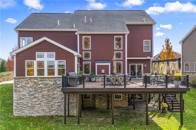 back of house featuring a wooden deck and a yard