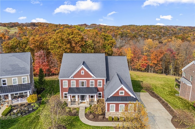 back of property with a yard and covered porch