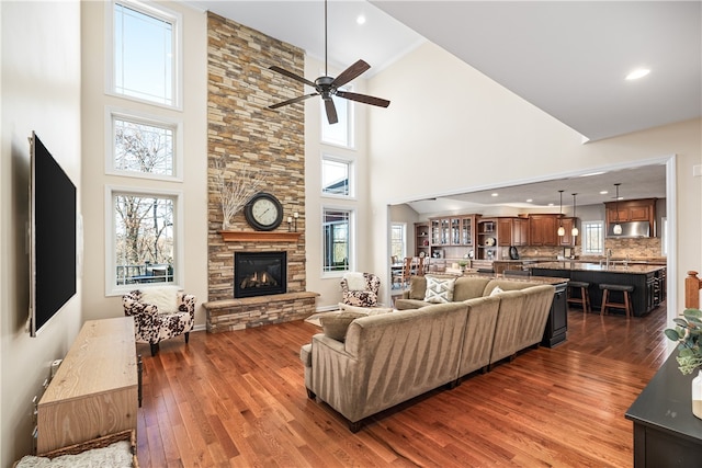 living room with hardwood / wood-style floors and a towering ceiling