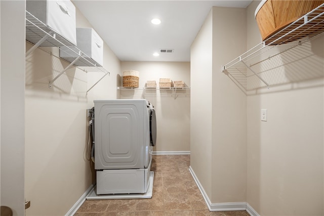 washroom featuring separate washer and dryer and tile patterned flooring