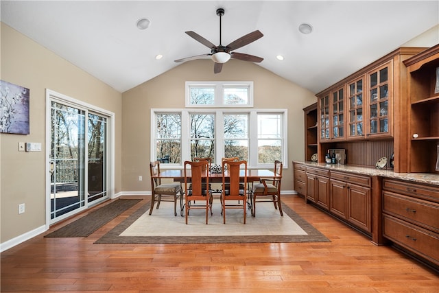 dining area with light hardwood / wood-style flooring, lofted ceiling, and ceiling fan