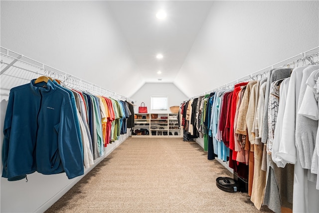 walk in closet with carpet flooring and vaulted ceiling