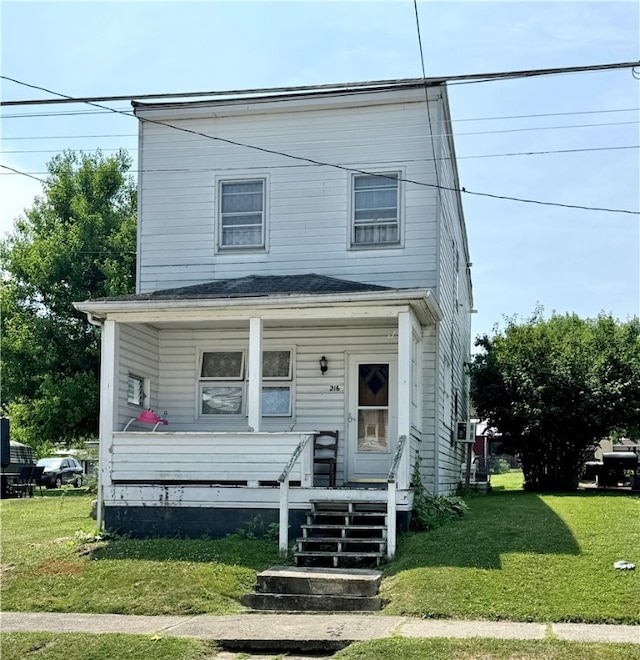 view of front of house with a front yard and covered porch