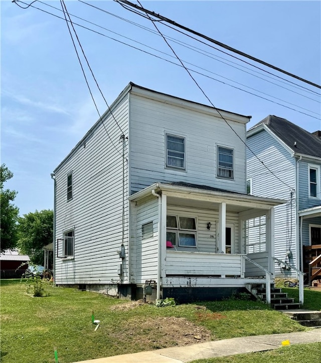 view of front of property with a porch and a front lawn