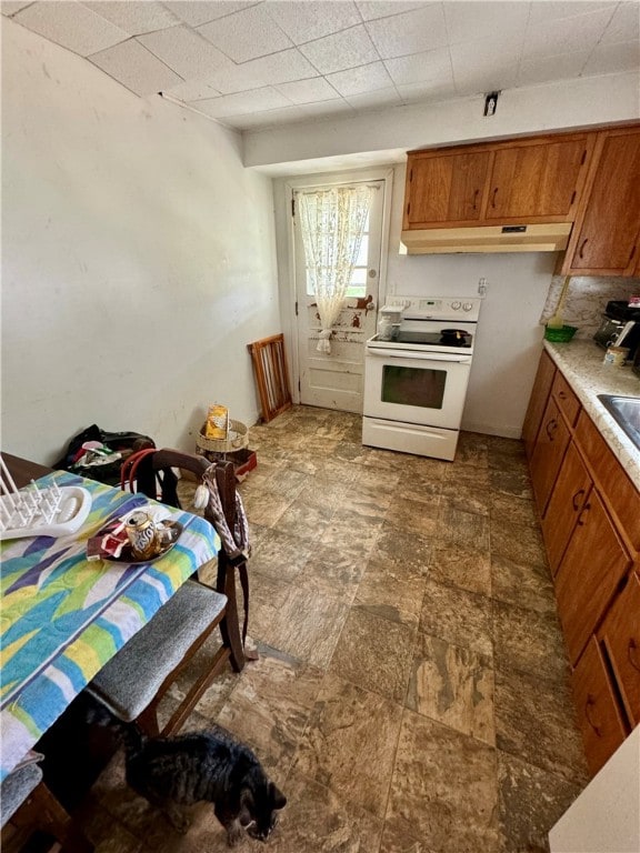 kitchen with backsplash and white electric range oven