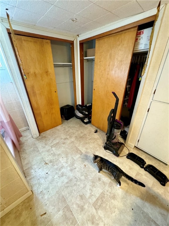 unfurnished bedroom featuring a drop ceiling