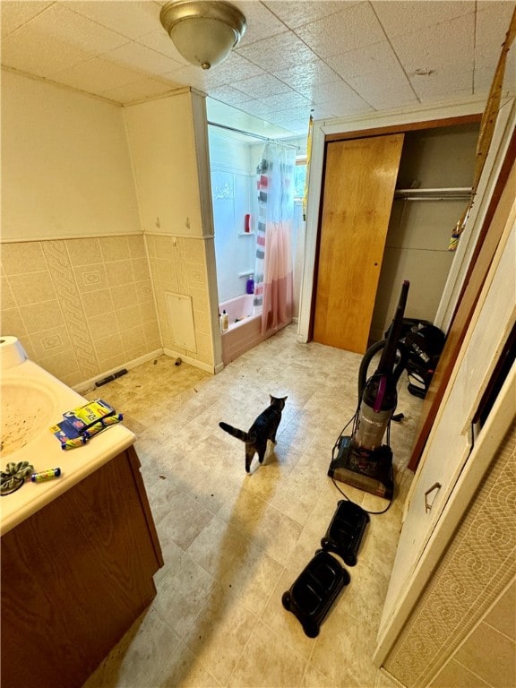 bedroom with tile walls and a closet