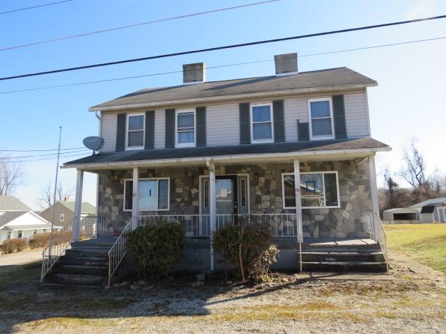 view of front of home with stone siding and covered porch