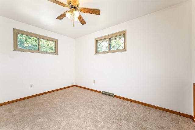 empty room with carpet flooring and plenty of natural light