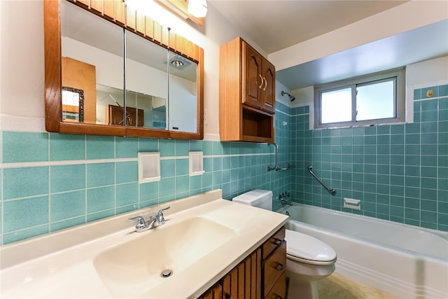 full bathroom with toilet, vanity, tiled shower / bath combo, and tile walls