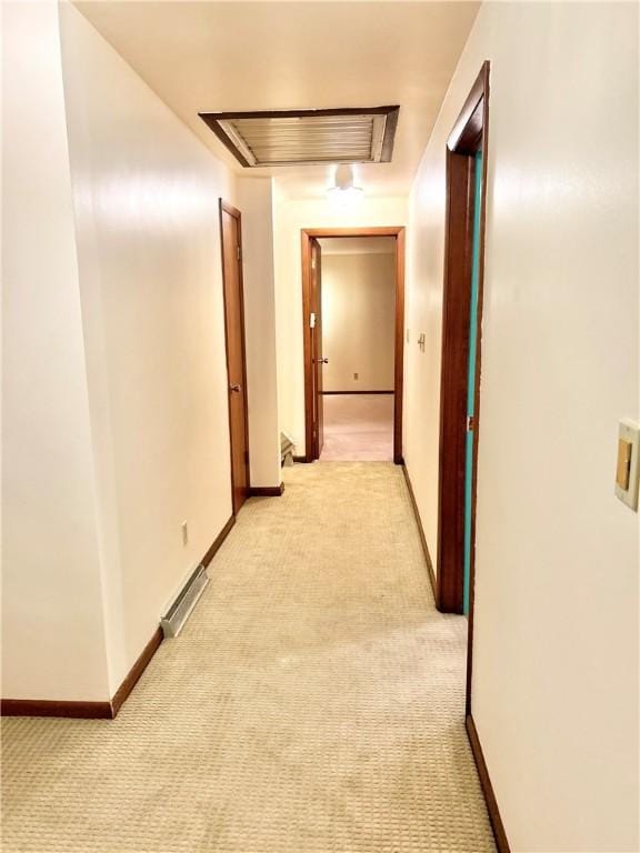 corridor with light colored carpet