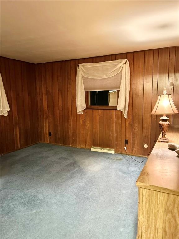 unfurnished room featuring light colored carpet and baseboard heating