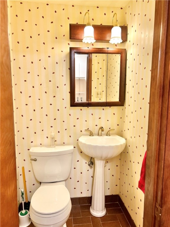 bathroom featuring tile patterned flooring and toilet