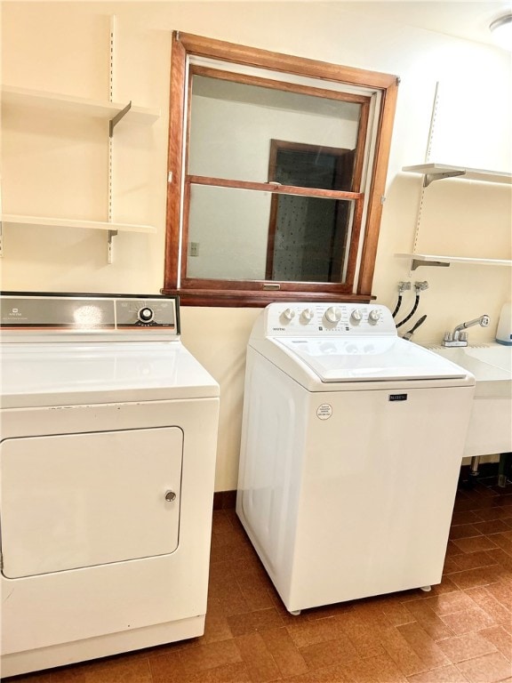 laundry room featuring washer and dryer and sink