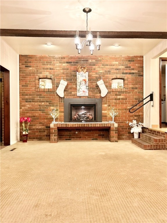 unfurnished living room with carpet flooring, a fireplace, beamed ceiling, and a chandelier