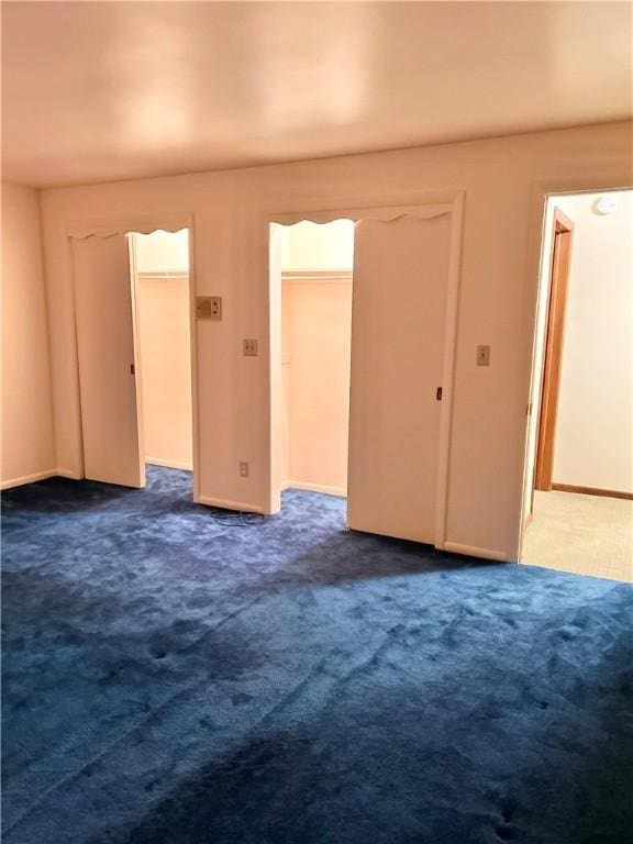 empty room with dark colored carpet