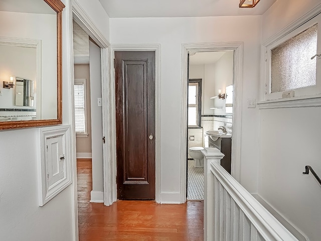 hallway with light hardwood / wood-style flooring