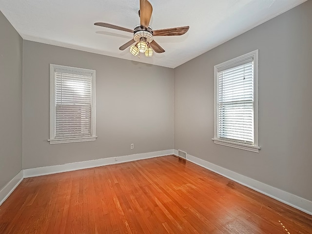 unfurnished room featuring hardwood / wood-style floors and ceiling fan