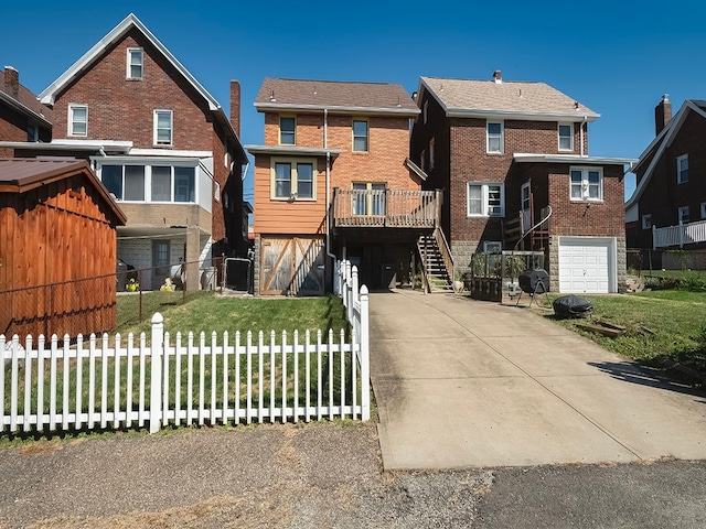 view of front of house with a front lawn, a garage, and a wooden deck